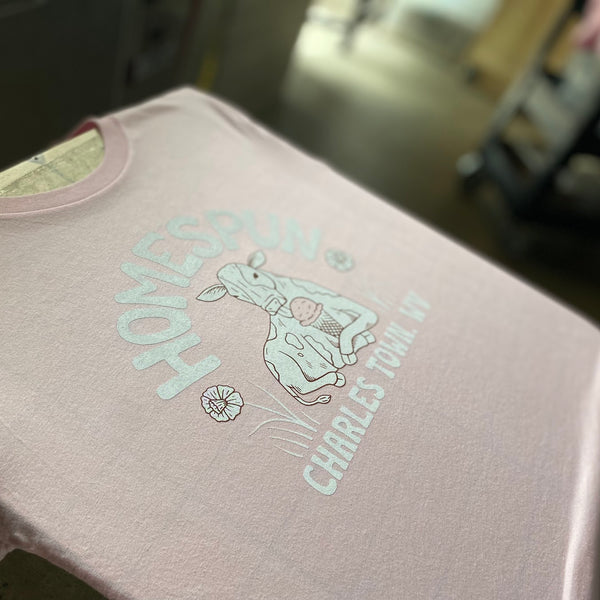 Homespun cow design in light ink on a Heather Pink Bella+Canvas 3001CVC tee at RVA Threads screen printing, Virginia