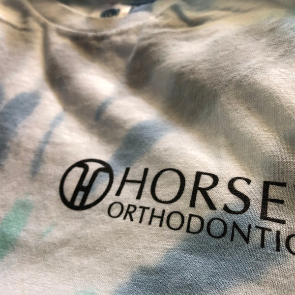 Horsey Orthodontics logo in black ink on a pastel tie-dye tee at RVA Threads screen printing, Virginia
