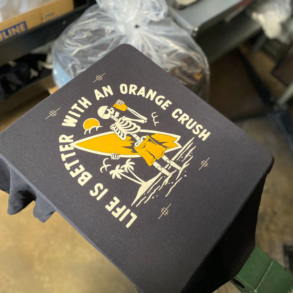 Life Is Better With An Orange Crush design on a navy tee on the press pallet at RVA Threads screen printing, Virginia