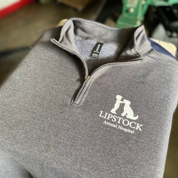 Lipstock Animal Hospital logo in white ink on a gray quarter zip pullover at RVA Threads screen printing, Virginia