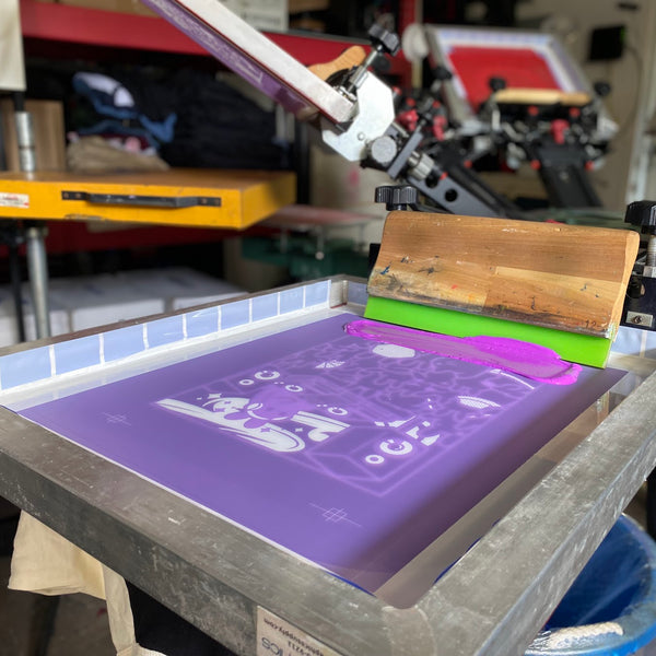 Meow Royale DJ bunny screen with the squeegee loaded on the press, ready for the next pull at RVA Threads screen printing, Virginia