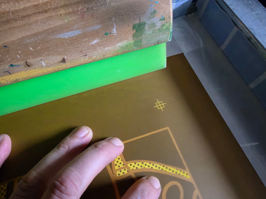 Burned Meow Royale DJ Rabbit screen with halftone dots and a registration mark beside a green squeegee at RVA Threads screen printing, Virginia