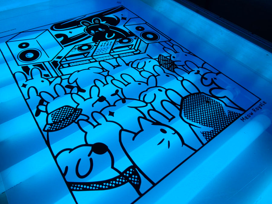 Meow Royale DJ Rabbit film positive laid on the exposure unit glass under the blue light at RVA Threads screen printing, Virginia