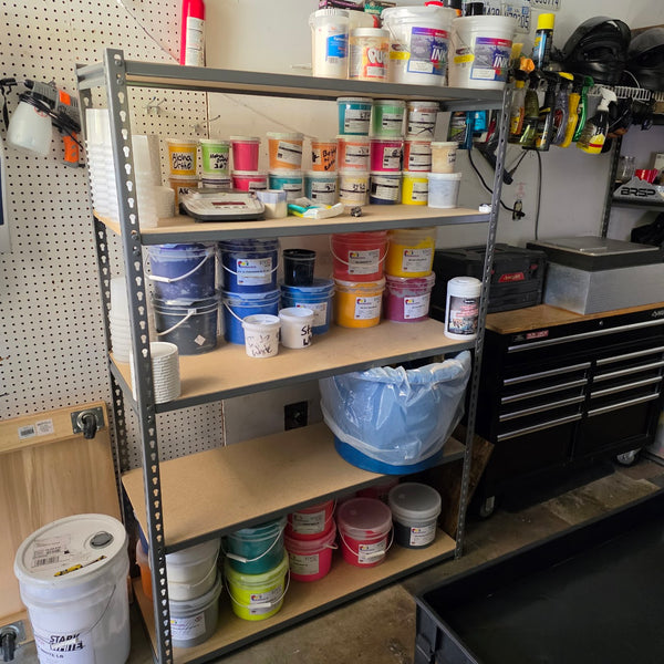 Shelves stocked with plastisol ink buckets, cups and mixing supplies, ready for color matching at RVA Threads screen printing, Virginia