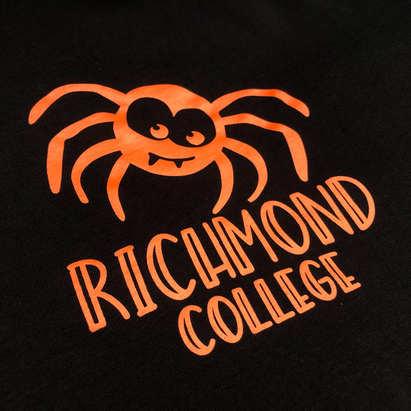 Richmond College spider logo in orange ink on a black tee, close up at RVA Threads screen printing, Virginia