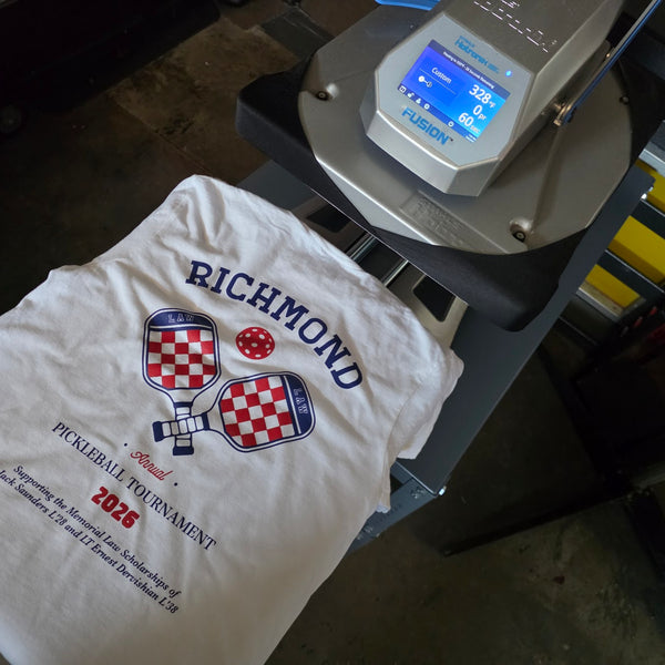 Richmond Law Pickleball Tournament tee in navy and red ink laid out on the heat press at RVA Threads screen printing, Virginia