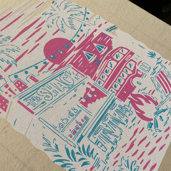 The Shack beach scene with the first pink and teal colors laid down on the pallet at RVA Threads screen printing, Virginia