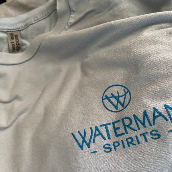 Waterman Spirits logo in blue ink on a natural tee, close up at RVA Threads screen printing, Virginia