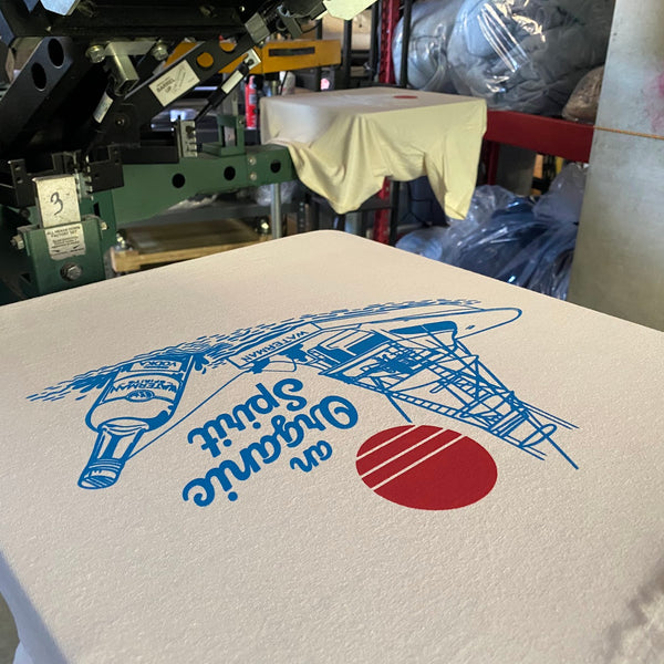 Waterman Spirits An Organic Spirit design in blue and red on a white tee on the pallet at RVA Threads screen printing, Virginia