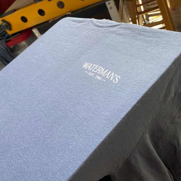 Waterman's left chest logo in white ink on a gray tee on the press pallet at RVA Threads screen printing, Virginia